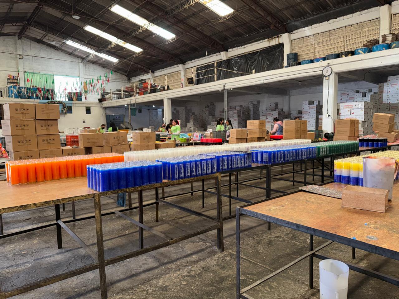 Mesas con veladoras naranjas, blancas y azules recién vaciadas